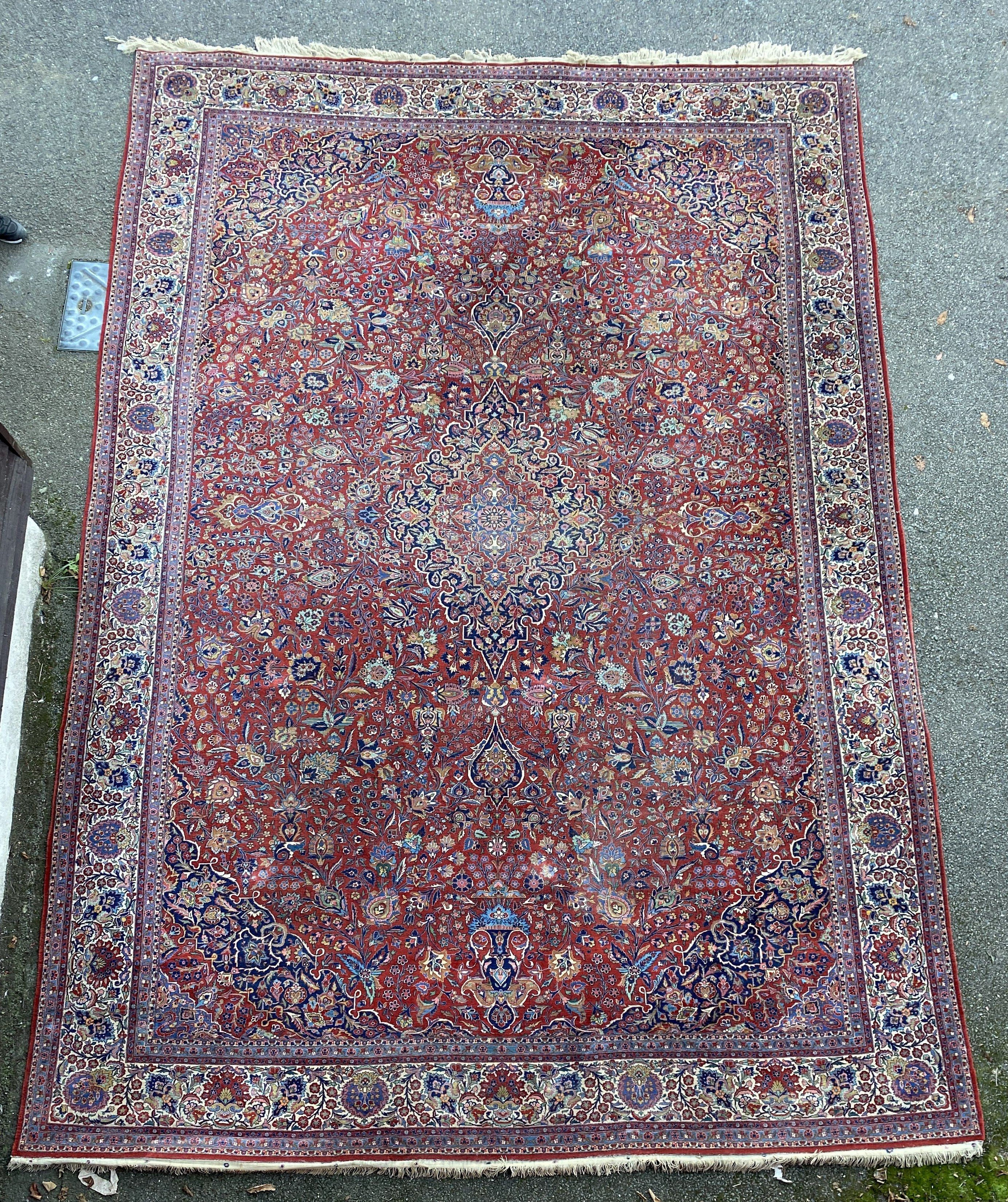 A Tabriz red ground carpet with, first half 20th century, 510cm x 355cm